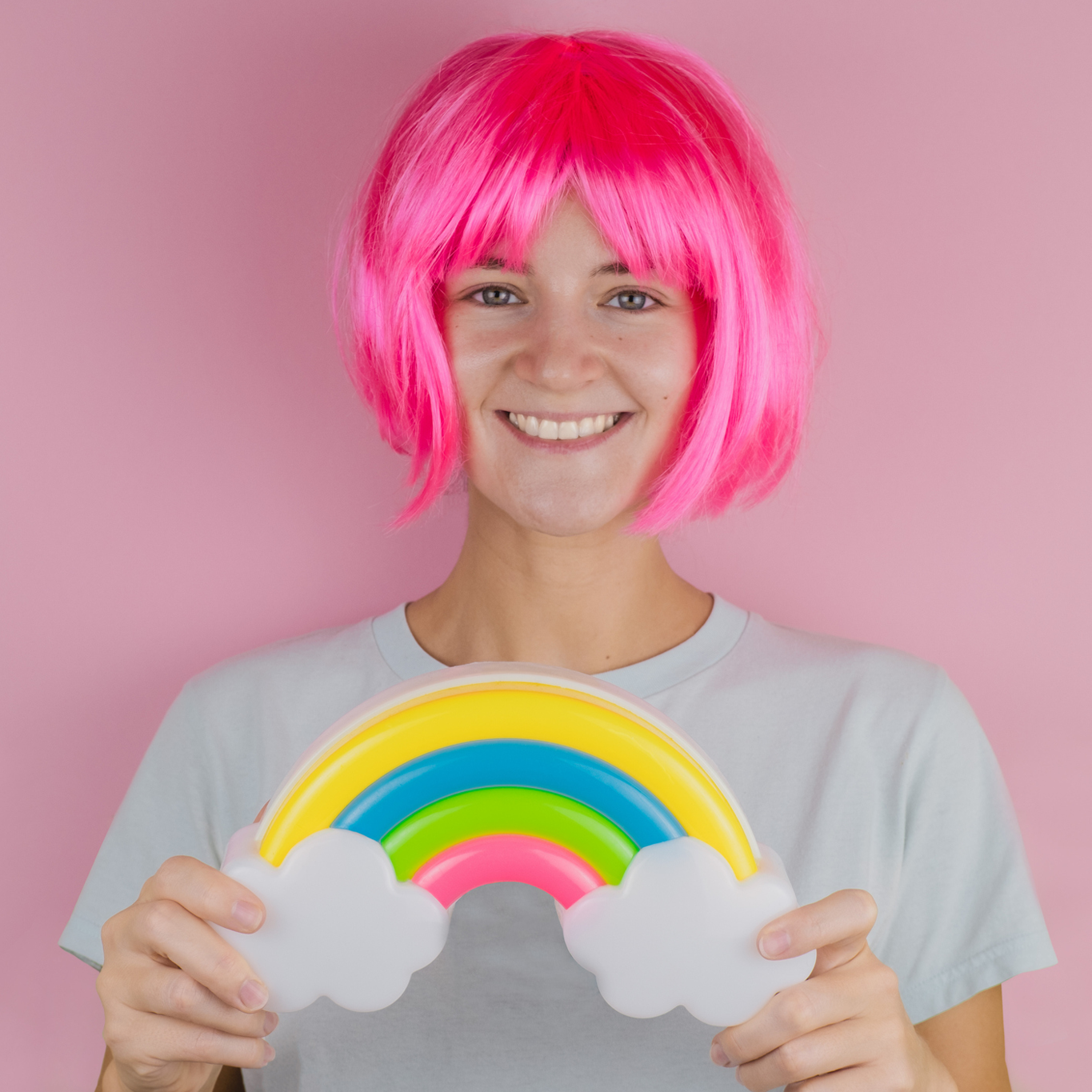 beautiful-smiling-happy-woman-with-pink-hair-holding-plastic-rainbow-picture-id1223549904